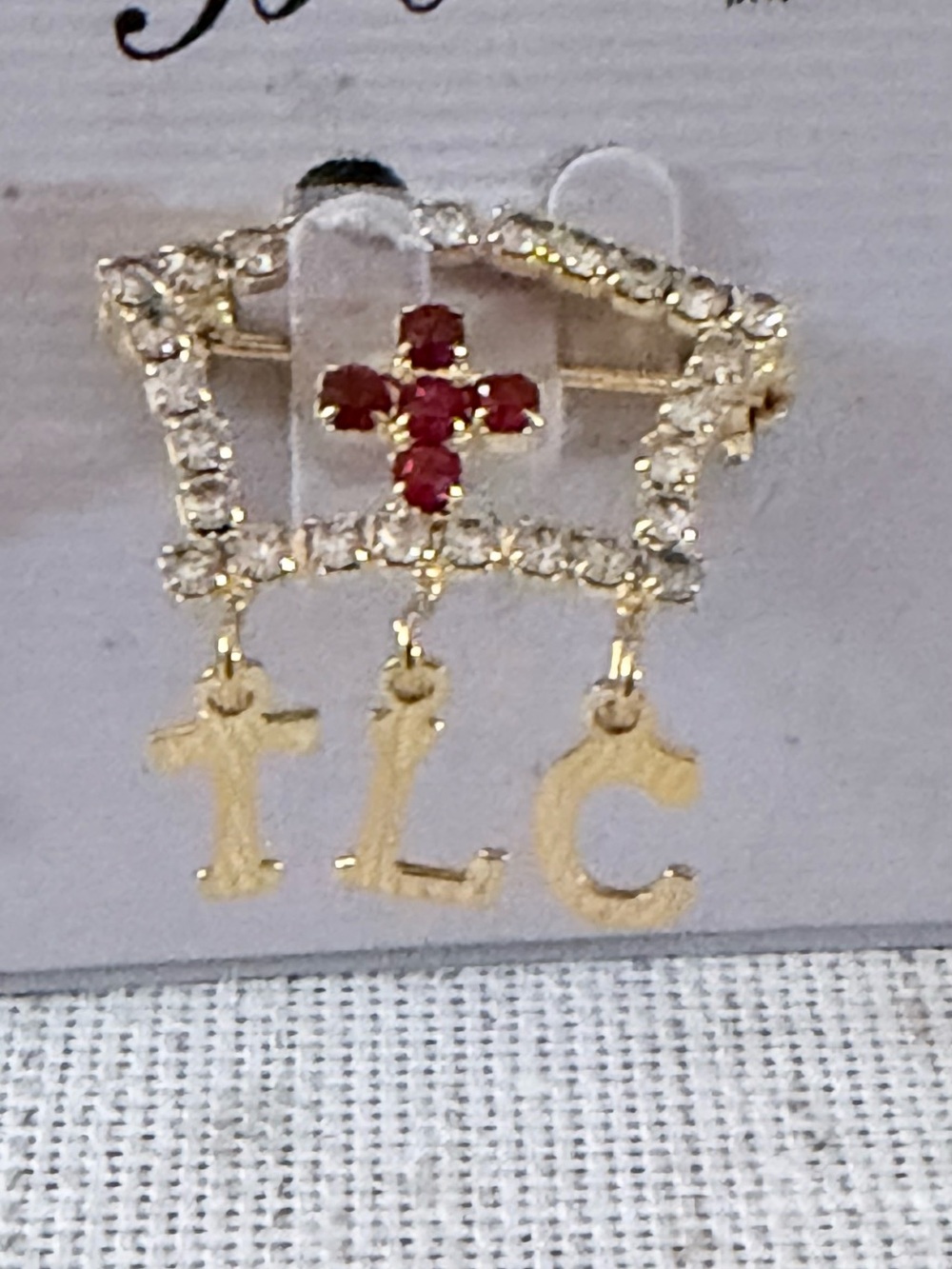 Gold-Tone Crown Brooch with Red Crystal Cross and TLC Letter Charms
